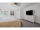 Bright bedroom with ceiling fan, white dresser, and large television for entertainment at 234 Pam Sw Ln, Marietta, GA 30064