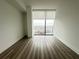 Bright bedroom featuring a large window and hardwood floors at 788 W Marietta Nw St # 905, Atlanta, GA 30318