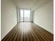 Bedroom with hardwood floors and large window at 788 W Marietta Nw St # 905, Atlanta, GA 30318