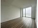 Bright bedroom featuring a large window and hardwood floors at 788 W Marietta Nw St # 905, Atlanta, GA 30318