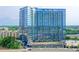 Modern high-rise building showcasing a sleek glass facade with a view of surrounding green landscape at 788 W Marietta Nw St # 905, Atlanta, GA 30318
