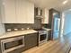 Modern kitchen with stainless steel appliances, sleek cabinetry, and stylish subway tile backsplash at 788 W Marietta Nw St # 905, Atlanta, GA 30318