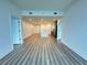 Modern living room with hardwood floors opens to kitchen with island and stainless appliances at 788 W Marietta Nw St # 905, Atlanta, GA 30318