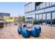 Inviting outdoor seating area with a fire pit and contemporary blue chairs for comfortable relaxation at 788 W Marietta Nw St # 905, Atlanta, GA 30318