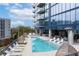 Resort-style pool area with lounge chairs, umbrellas, and a hot tub for ultimate relaxation at 788 W Marietta Nw St # 905, Atlanta, GA 30318