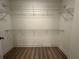 Walk-in closet with wood floors and wire shelving at 788 W Marietta Nw St # 905, Atlanta, GA 30318