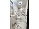 Bathroom features a modern vanity, marble accent wall, and a shower-tub combo at 1959 Oana Sw St, Atlanta, GA 30310