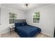 Bedroom features two windows for natural light, blue bedding, and modern accents at 1959 Oana Sw St, Atlanta, GA 30310