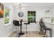 Cozy dining area featuring modern lighting, bar-stool seating, and a view of the backyard at 1959 Oana Sw St, Atlanta, GA 30310