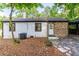 Exterior view of the home showcasing mixed cladding, a side entrance, and a convenient carport at 1959 Oana Sw St, Atlanta, GA 30310