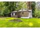 Inviting single-story home with fresh landscaping, stone details, and a convenient carport nestled in a wooded lot at 1959 Oana Sw St, Atlanta, GA 30310