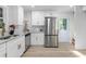 Well-lit kitchen with stainless steel appliances, white cabinetry, and marble countertops at 1959 Oana Sw St, Atlanta, GA 30310