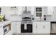 Well-lit kitchen featuring stainless steel appliances, white cabinetry, and marble countertops at 1959 Oana Sw St, Atlanta, GA 30310