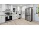 Updated kitchen with stainless steel appliances, white cabinets, and a modern aesthetic, perfect for cooking and entertaining at 1959 Oana Sw St, Atlanta, GA 30310