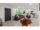 Open-concept living room boasts hardwood floors, neutral tones, and ample natural light from large windows at 1959 Oana Sw St, Atlanta, GA 30310