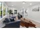 Bright and airy living room with hardwood floors flowing into an adjacent breakfast nook and kitchen at 1959 Oana Sw St, Atlanta, GA 30310