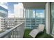 Balcony view with lounge chair, glass panels, city views and synthetic grass flooring at 20 10Th Nw St # 704, Atlanta, GA 30309