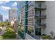 Modern condo building exterior with multiple balconies overlooking tree-lined streets and high-rise views at 20 10Th Nw St # 704, Atlanta, GA 30309