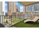 Relaxing balcony features stylish furniture, turf and city views at 20 10Th Nw St # 704, Atlanta, GA 30309