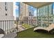 Relaxing balcony features stylish furniture, turf and city views at 20 10Th Nw St # 704, Atlanta, GA 30309