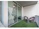 Cozy balcony with synthetic grass, seating and decorative pillows at 20 10Th Nw St # 704, Atlanta, GA 30309