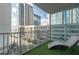 Urban balcony with synthetic grass flooring, lounge chair, and panoramic city views at 20 10Th Nw St # 704, Atlanta, GA 30309