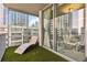 Relaxing balcony featuring a stylish chaise lounge and city views at 20 10Th Nw St # 704, Atlanta, GA 30309