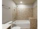 Clean bathroom featuring a bathtub with shower and attractive tile surround, with neutral colors for a calming feel at 20 10Th Nw St # 704, Atlanta, GA 30309