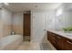 Well-lit bathroom with double vanity, soaking tub, and elegant tile accents at 20 10Th Nw St # 704, Atlanta, GA 30309