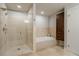 Luxurious bathroom showcasing a glass-enclosed shower and separate soaking tub at 20 10Th Nw St # 704, Atlanta, GA 30309