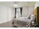 Modern bedroom features hardwood floors, contemporary lighting, and a large window at 20 10Th Nw St # 704, Atlanta, GA 30309