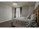 Cozy bedroom with a modern light fixture, sleek hardwood floors, and a luxurious bed with a decorative headboard at 20 10Th Nw St # 704, Atlanta, GA 30309