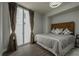 Bright bedroom featuring hardwood floors, a large window, and a comfortable-looking bed with stylish bedding at 20 10Th Nw St # 704, Atlanta, GA 30309