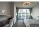 Bright bedroom with a dedicated workspace and large windows showcasing city views at 20 10Th Nw St # 704, Atlanta, GA 30309