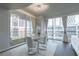 A bright dining room featuring seating for four, hardwood floors, modern lighting, and a floor-to-ceiling view at 20 10Th Nw St # 704, Atlanta, GA 30309