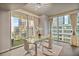 Bright dining room with glass table, city views, and modern decor at 20 10Th Nw St # 704, Atlanta, GA 30309