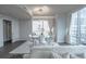 Bright dining room featuring a glass table, seating for six, hardwood floors, and a floor-to-ceiling view at 20 10Th Nw St # 704, Atlanta, GA 30309