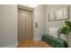 Building elevator entrance area, with a decorative wall hanging, modern bench and tile flooring at 20 10Th Nw St # 704, Atlanta, GA 30309
