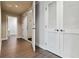 Bright hallway featuring hardwood floors, storage closets, and neutral decor at 20 10Th Nw St # 704, Atlanta, GA 30309
