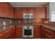 A beautifully designed kitchen with granite countertops, stainless steel appliances, wood cabinets, and tile backsplash at 20 10Th Nw St # 704, Atlanta, GA 30309