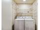 Functional laundry area featuring a washer, dryer, and overhead shelving at 20 10Th Nw St # 704, Atlanta, GA 30309