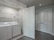 Functional laundry room with modern washer and dryer, ample shelving, and convenient storage solutions for ease at 20 10Th Nw St # 704, Atlanta, GA 30309