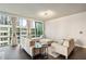 Stylish living area featuring modern furniture, hardwood floors, and large windows at 20 10Th Nw St # 704, Atlanta, GA 30309