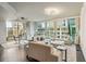 Bright, modern living room with hardwood floors, comfortable seating, and floor-to-ceiling windows offering city views at 20 10Th Nw St # 704, Atlanta, GA 30309