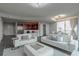 Bright living room features hardwood floors, modern furniture, a bar area, and a view of the city at 20 10Th Nw St # 704, Atlanta, GA 30309