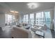 Bright living room featuring hardwood floors, neutral furnishings, and a floor-to-ceiling view of the city at 20 10Th Nw St # 704, Atlanta, GA 30309
