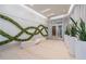 Open-concept lobby space with designer bench, decorative accent wall and tile floors at 20 10Th Nw St # 704, Atlanta, GA 30309