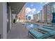 Rooftop pool and sundeck surrounded by lounge chairs and cityscape views at 20 10Th Nw St # 704, Atlanta, GA 30309