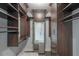 Spacious walk-in closet with custom shelves, drawers, and a full-length mirror at 20 10Th Nw St # 704, Atlanta, GA 30309