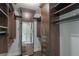 Large walk-in closet with custom shelving, drawers, and a mirrored door at 20 10Th Nw St # 704, Atlanta, GA 30309